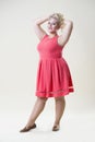 Plus size fashion model, fat woman on beige background, overweight female body