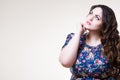 Plus size fashion model in floral blouse, fat woman on beige background with copy space