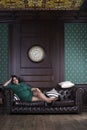 Plus size fashion model in green evening dress, fat woman on luxury interior, overweight female body Royalty Free Stock Photo