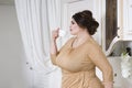 Plus size fashion model on kitchen, fat woman on luxury interior, overweight female body Royalty Free Stock Photo