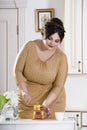 Plus size fashion model on kitchen, fat woman on luxury interior, overweight female body Royalty Free Stock Photo