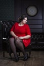 Plus size fashion model in red evening dress, fat woman on luxury interior, overweight female body, full length portrait Royalty Free Stock Photo