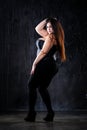 Plus size fashion model in sexy clothes, fat woman on black background, body positive concept Royalty Free Stock Photo