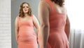 Plus-size female looking in mirror, upset about her weight, suffer insecurities