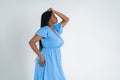 Plus size female model posing in blue dress on white background, young African woman with curvy figure and pigtailed hairstyle, Royalty Free Stock Photo