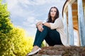 Plus size girl sits on an old brick wall Royalty Free Stock Photo