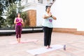 Plus size latin girl meditating with closed eyes standing in outdoor yoga class in Latin America Royalty Free Stock Photo