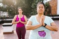 Plus size latin girl meditating with closed eyes standing in outdoor yoga class in Latin America Royalty Free Stock Photo