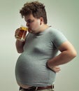 Plus size, man and drinking alcohol for unhealthy habit, belly and weight gain in studio of isolated white background Royalty Free Stock Photo