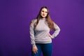 Plus size model in casual clothes, fat woman on purple background