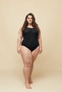 Plus Size Model. Fat Woman In Black Bodysuit Full-length Portrait. Brunette Standing And Looking At Camera. Royalty Free Stock Photo