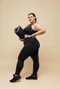 Plus Size Model. Fat Woman In Black Sportswear Full-Length Portrait. Smiling Brunette Holding Fitness Mat.