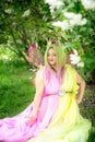 Plus size model in the form of a butterfly in a green blooming green garden. Fairy tale