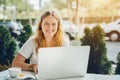 Plus size model girl working on laptop in cafe Royalty Free Stock Photo