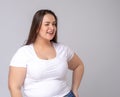 Plus Size Model with long hair posing in studio. Winks, blinks