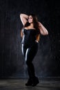 Plus size model in sexy clothes, fat woman on dark background, overweight female body