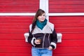 Plus size model in winter look with coffee