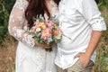 Plus size wedding couple is standing and hugging outside. Curvy