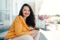 Plus size woman drinking spinach smoothie while walking the city street Royalty Free Stock Photo