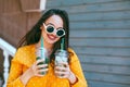 Plus size woman drinking take away cocktail over city cafe wall Royalty Free Stock Photo