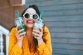 Plus size woman drinking take away cocktail over city cafe wall Royalty Free Stock Photo