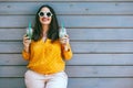 Plus size woman drinking take away cocktail over city cafe wall Royalty Free Stock Photo