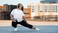 Plus size woman stretching her leg. Young curvy female exercising