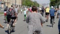 Plus size woman wearing dress biking in city