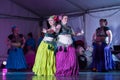 Plus-sized female tribal belly dancers performing on stage