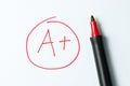 A plus written with red pen Royalty Free Stock Photo