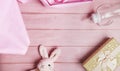 Plush baby toy rabbit for a newborn with toys, top view on a pink wooden background Royalty Free Stock Photo