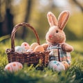 A plush bunny toy sits beside a wicker basket filled with decorated Easter eggs on a lush green lawn. playful and Royalty Free Stock Photo