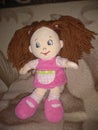 Plush doll in a pink dress