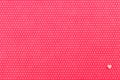 A plush fuchsia background in white polka dots with a decorated one small heart in the bottom right corner