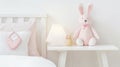 Plush rabbit white bedside cabinet next to cupboard, lamp pink DIY bags in child room. generative ai