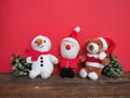 Plush sewn Christmas soft toys on a red background. Painted cones. A little smiling snowman, brown deer and a Royalty Free Stock Photo