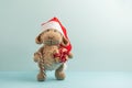Plush Sheep in Santa Hat Holding Gift Box and Cane Candy with Christmas Tree Royalty Free Stock Photo