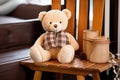 plush teddy bear on a small wooden rocking chair Royalty Free Stock Photo