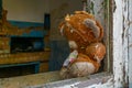 Plush teddy bear toy at a window of a house inside of the Chernobyl Exclusion Zone in the Ukraine