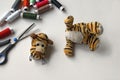 Plush tigger with a torn head. Sewing kit