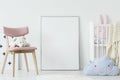 Plush toy on pink chair and blue pillow in child`s room interior