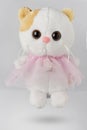 Plush white cat toy. A cat with a red ear Royalty Free Stock Photo