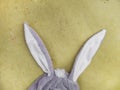 Plushy toy bunny rabbit ears. Happy easter concept. Yellow background. Easter minimal concept Picture with space for your text Royalty Free Stock Photo