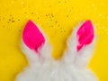 Plushy toy bunny rabbit ears. Happy easter concept. Yellow background. Easter minimal concept Picture with space for your text Royalty Free Stock Photo