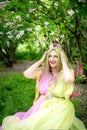 Plussize model in the form of a butterfly in a blooming garden. Fairytale