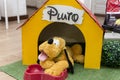 Pluto teddy bear in his yellow wooden house