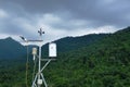 Pluviometer or rain gauge in mountain background with rain cloud on sky Royalty Free Stock Photo