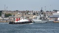 Military vessel HMS Mersey and a tugboat Royalty Free Stock Photo