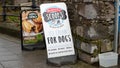 PLYMOUTH, DEVON, UK - March 06 2020: Signs on the pavement advertise Scoop`s Ice Cream For Dogs, and Proper Cornish pasties