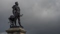 PLYMOUTH, DEVON, UK - March 06 2020: Sir Francis Drake statue overlooking The Hoe with storm clouds moving in Royalty Free Stock Photo